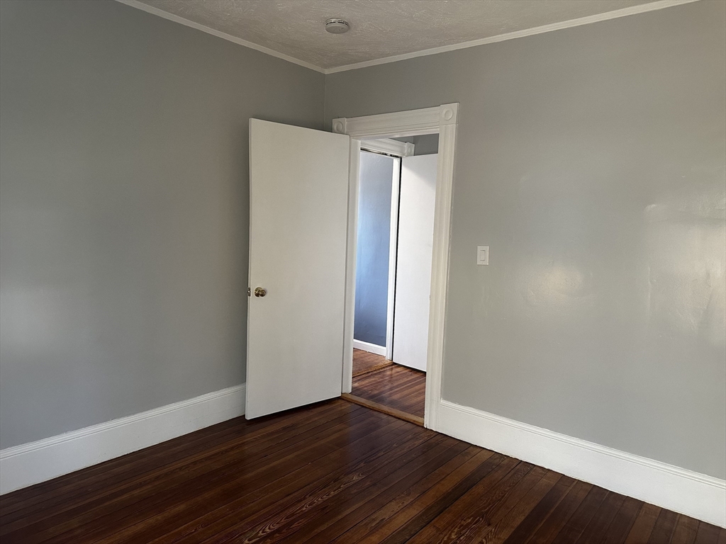 4 Howard Avenue, Unit 2 Attleboro, MA 02703 - Photo 10 of 17 a view of an empty room with wooden floor