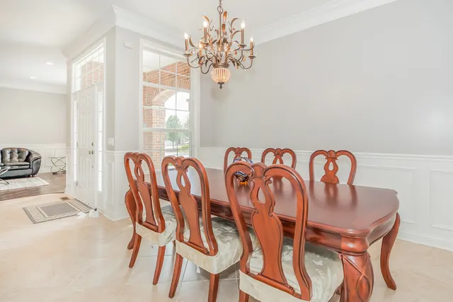 a view of a dining room with furniture and chandelier