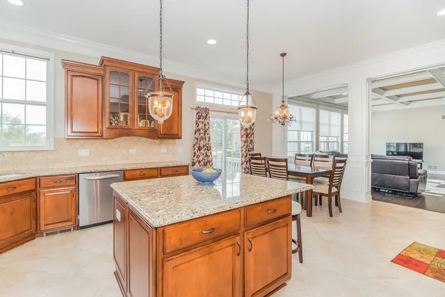 a kitchen with stainless steel appliances granite countertop stove top oven and cabinets