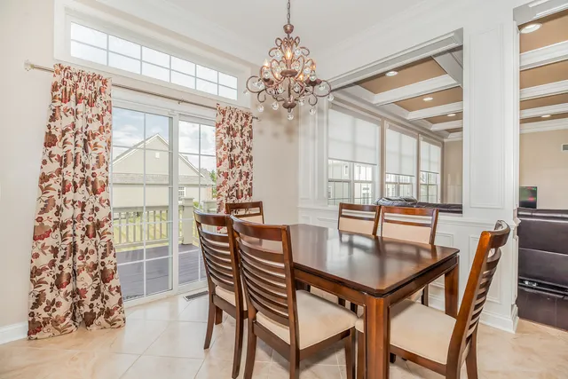 a dining room with furniture a chandelier and wooden floor
