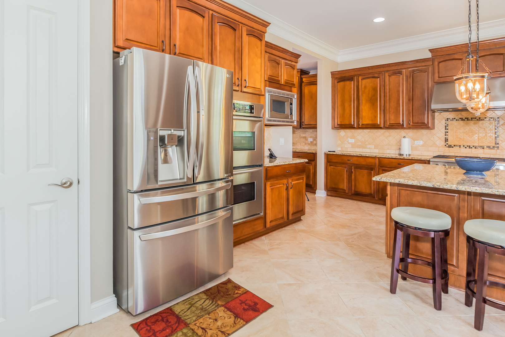 1115 Ashley Lane Inverness, IL 60010 - Photo 22 of 50 a kitchen with stainless steel appliances granite countertop a refrigerator and a stove top oven