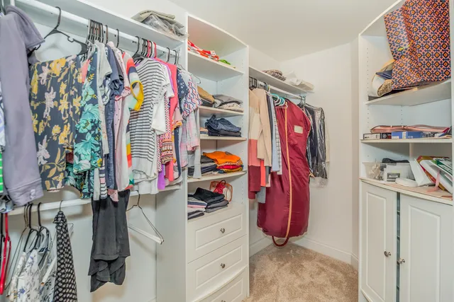 a view of walk in closet with clothes