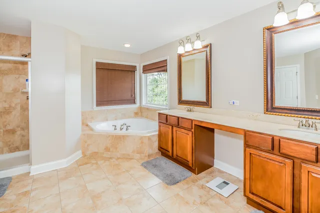 a bathroom with a bathtub sink and mirror
