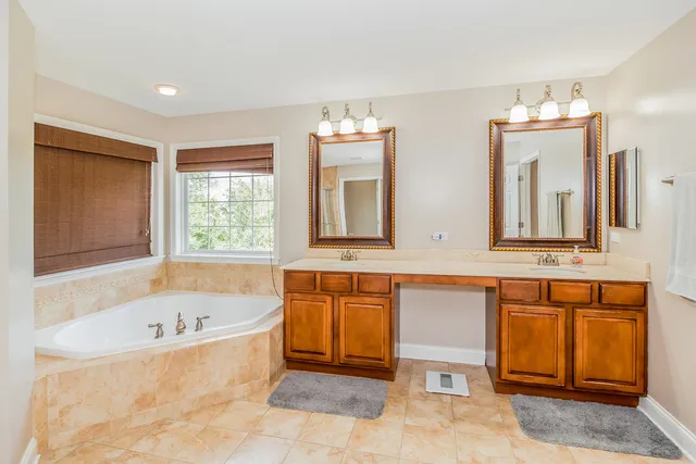 a bathroom with a bathtub a sink and a window