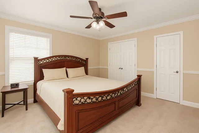 a bedroom with a bed and a chandelier