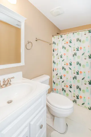 a white toilet sitting next to a bathroom sink