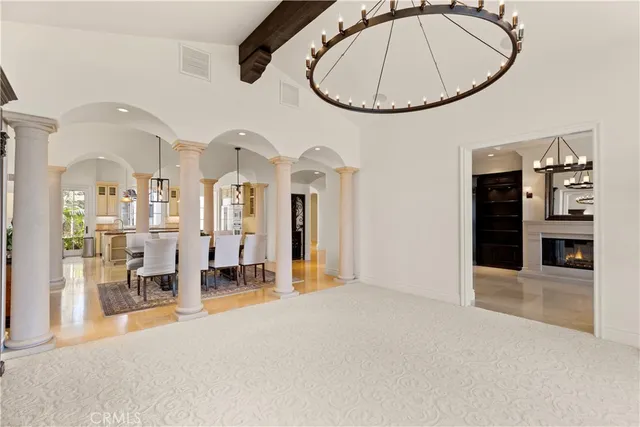 a large bedroom with bed tv and window