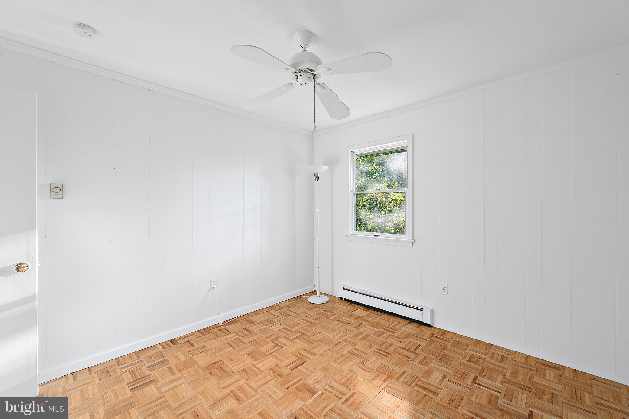 6181 Rockawalkin Road Salisbury, MD 21801 - Photo 38 of 65 an empty room with a window and a ceiling fan