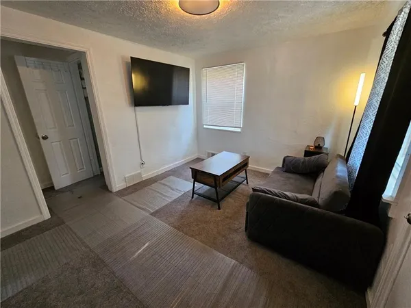 a kitchen with stainless steel appliances a stove refrigerator and microwave