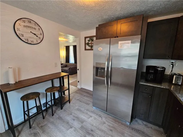 a kitchen with stainless steel appliances a stove a microwave a sink and cabinets