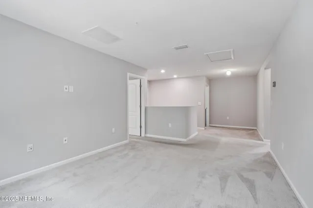 an empty room with a window and a ceiling fan