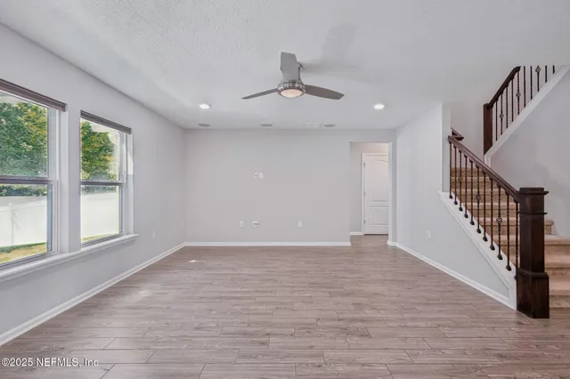 a large kitchen with stainless steel appliances granite countertop a lot of counter space and wooden floor