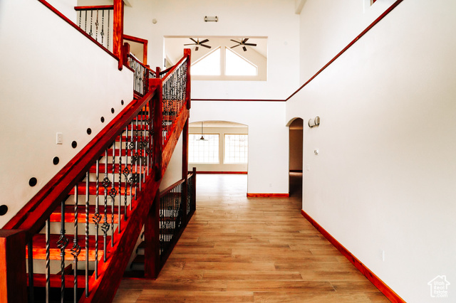 985 Russell Road Hatch, UT 84735 - Photo 5 of 30 Stairway featuring a high ceiling, plenty of natural light, arched walkways, and wood finished floors