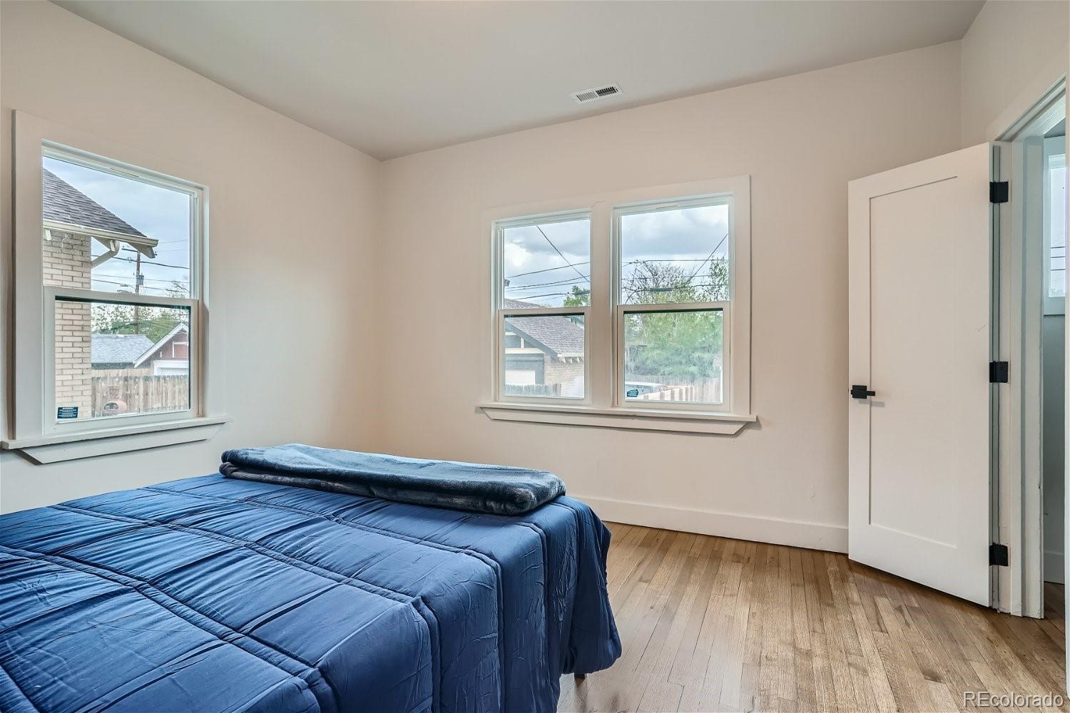 1400 Perry Street Denver, CO 80204 - Photo 12 of 26 a bedroom with a bed and wooden floor