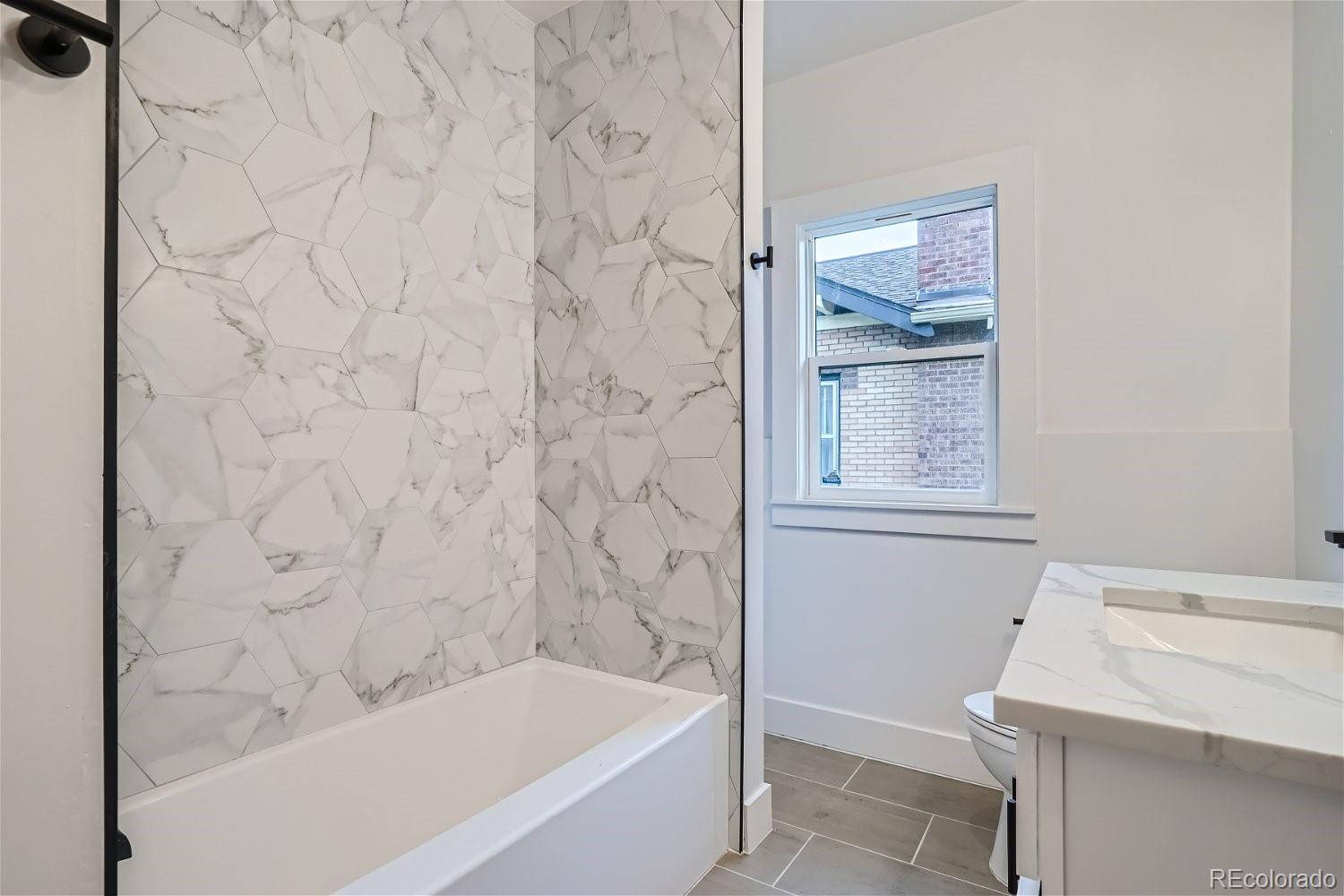 1400 Perry Street Denver, CO 80204 - Photo 13 of 26 a bathroom with a bathtub and shower