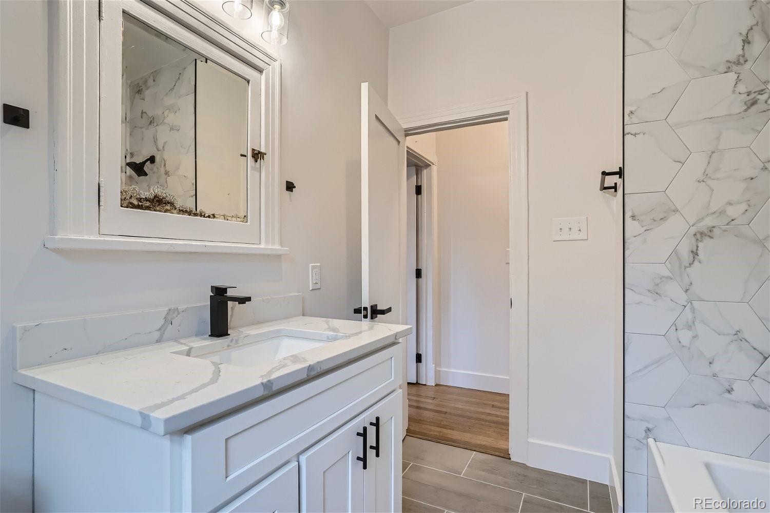 1400 Perry Street Denver, CO 80204 - Photo 14 of 26 a bathroom with a sink and a mirror
