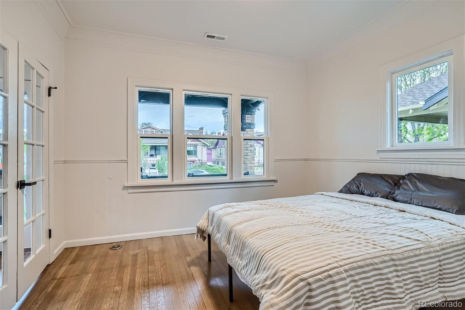 1400 Perry Street Denver, CO 80204 - Photo 15 of 26 a bedroom with a bed and a window