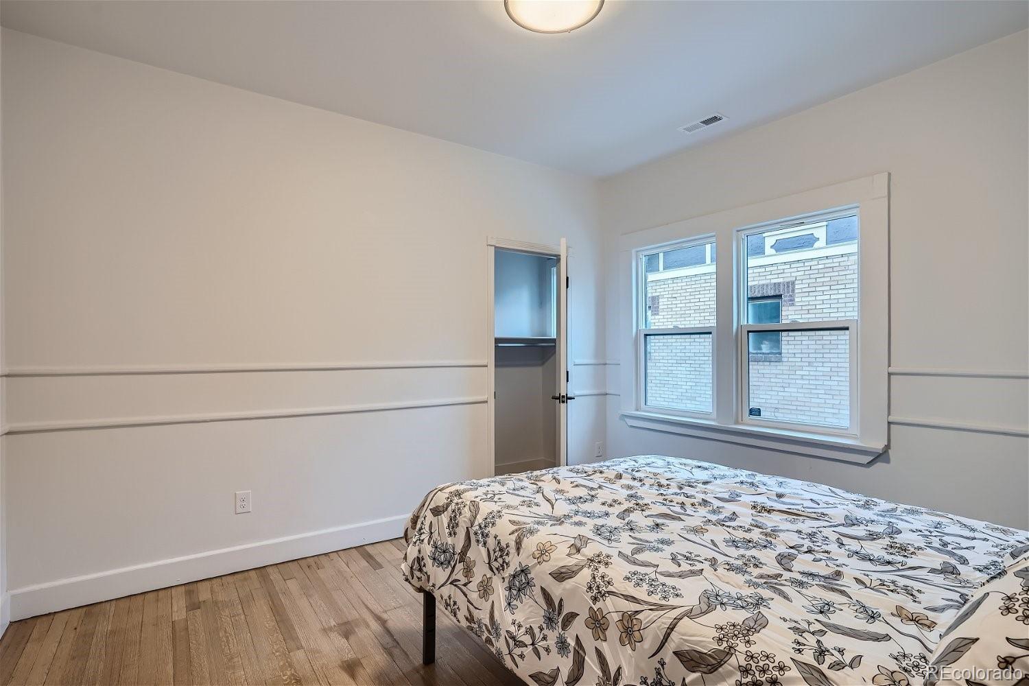 1400 Perry Street Denver, CO 80204 - Photo 16 of 26 a bedroom with a bed and a window