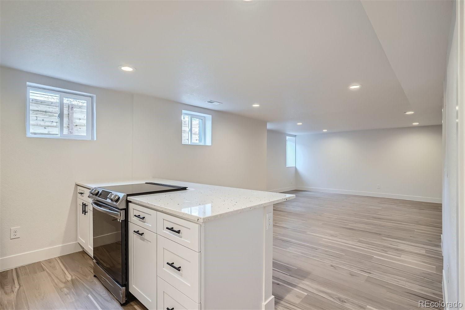 1400 Perry Street Denver, CO 80204 - Photo 18 of 26 a view of a kitchen counter space a stove and wooden floor