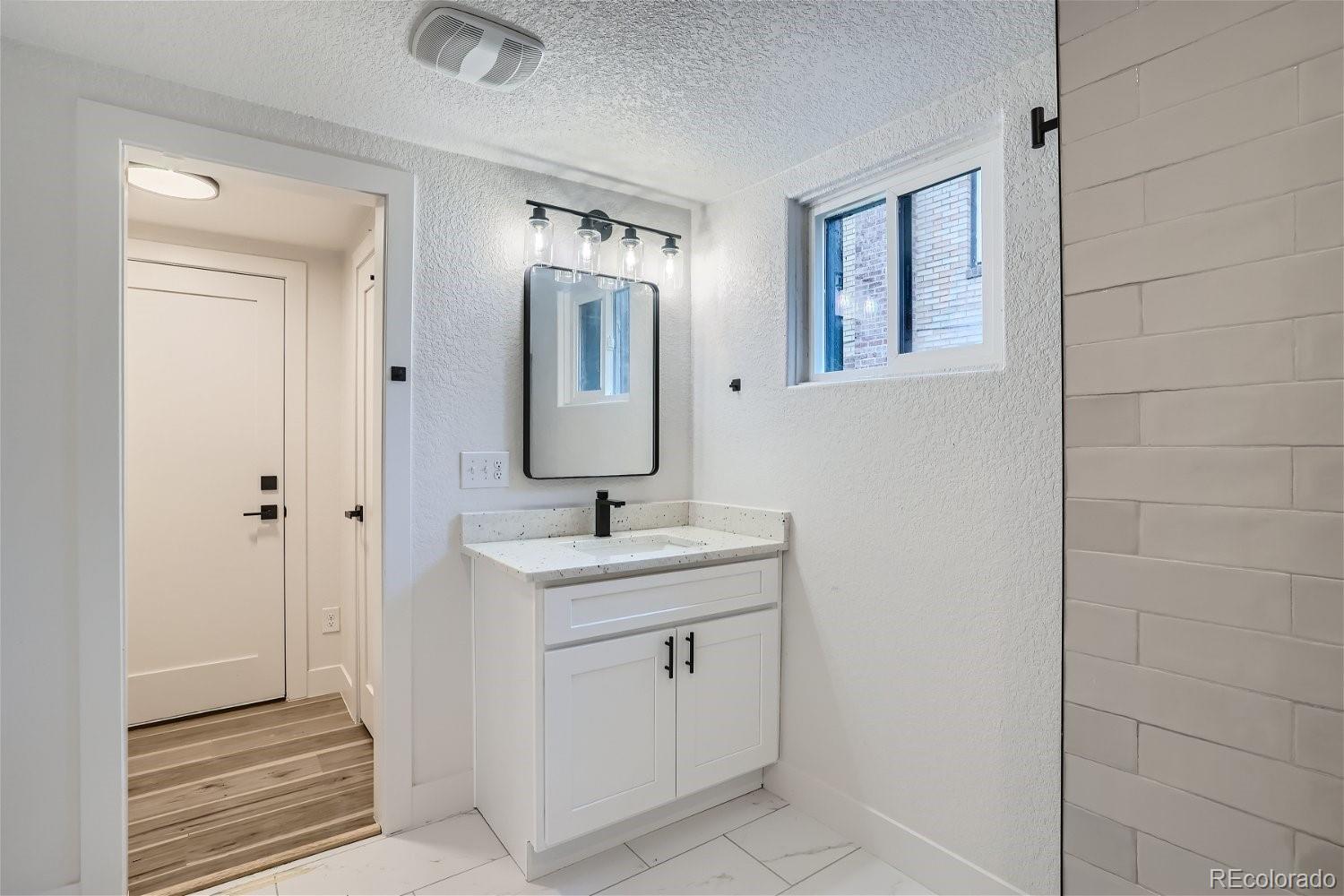 1400 Perry Street Denver, CO 80204 - Photo 21 of 26 a bathroom with a toilet sink and mirror