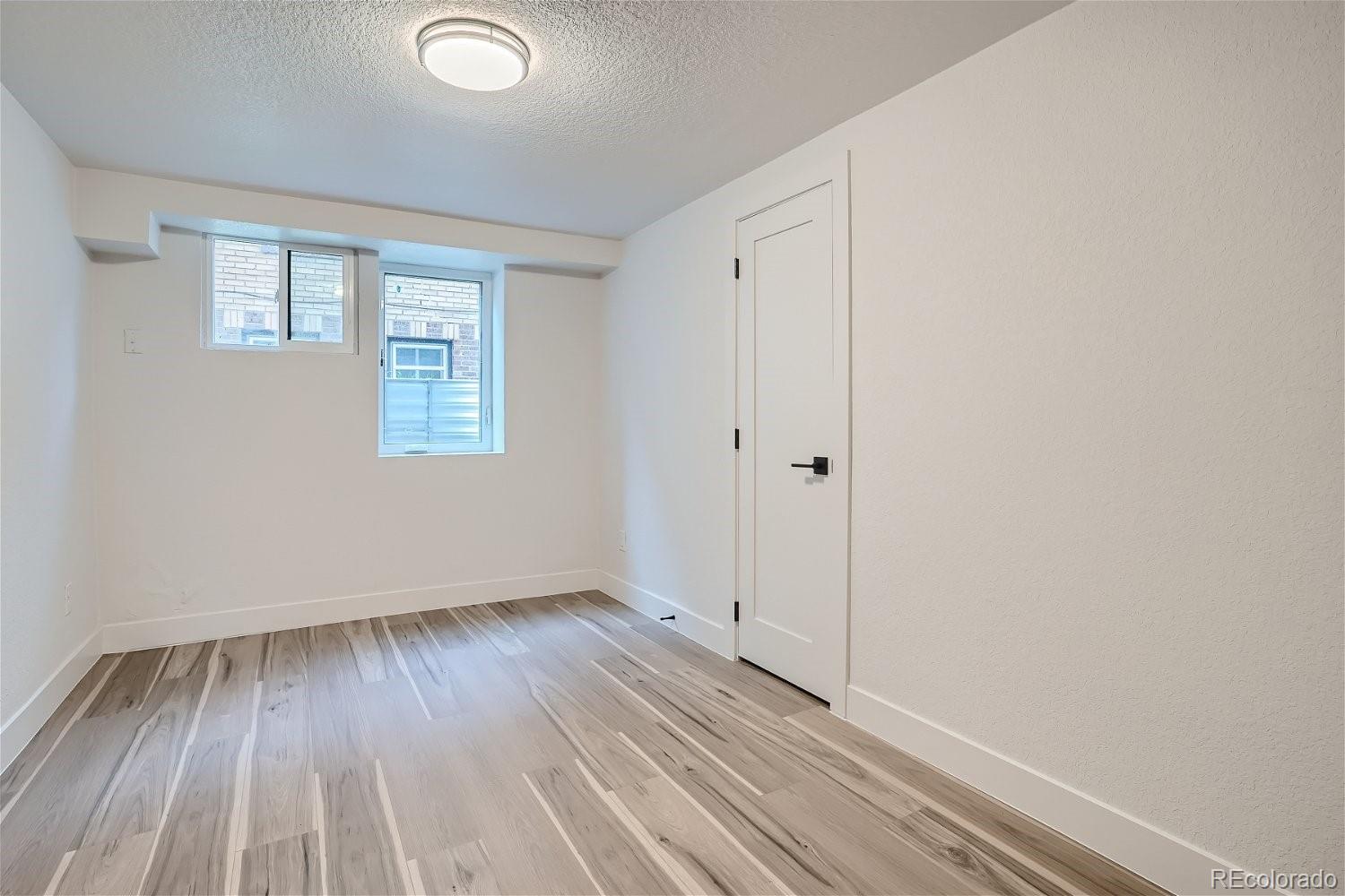 1400 Perry Street Denver, CO 80204 - Photo 22 of 26 a view of an empty room with wooden floor and a window