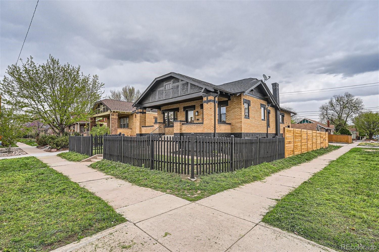 1400 Perry Street Denver, CO 80204 - Photo 3 of 26 a front view of a house with wooden fence