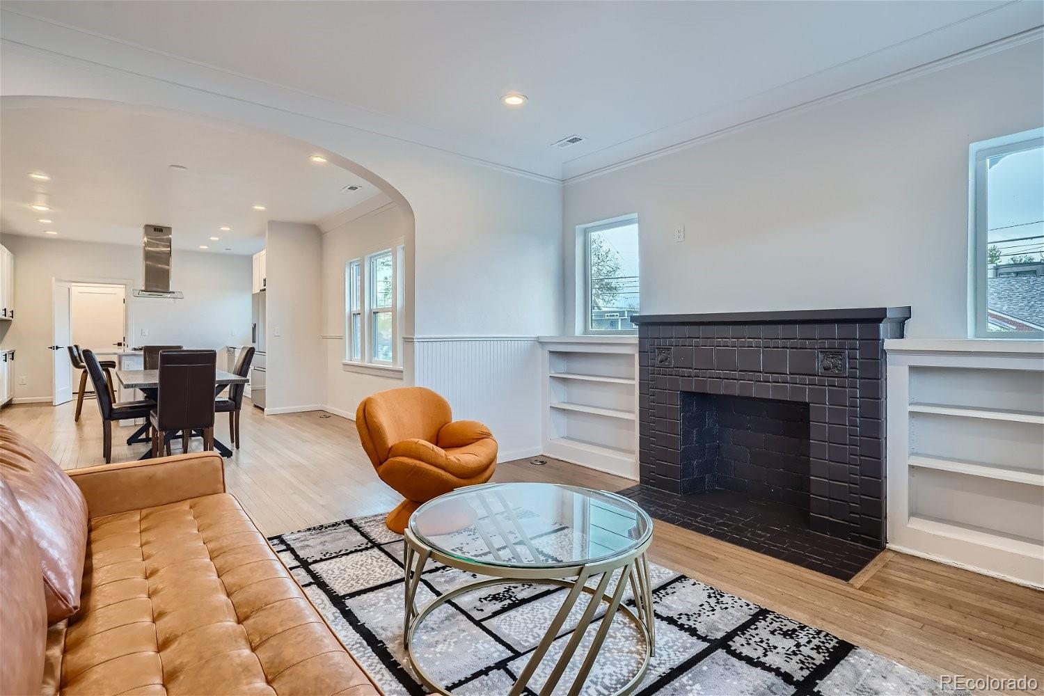 1400 Perry Street Denver, CO 80204 - Photo 5 of 26 a living room with furniture a fireplace and a table