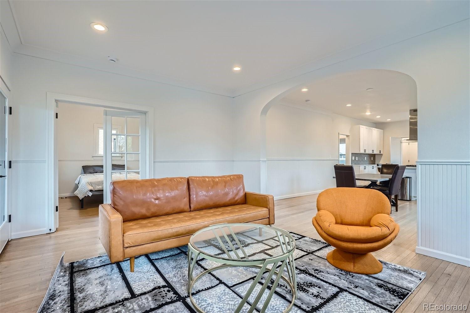 1400 Perry Street Denver, CO 80204 - Photo 6 of 26 a living room with a couch and a rug