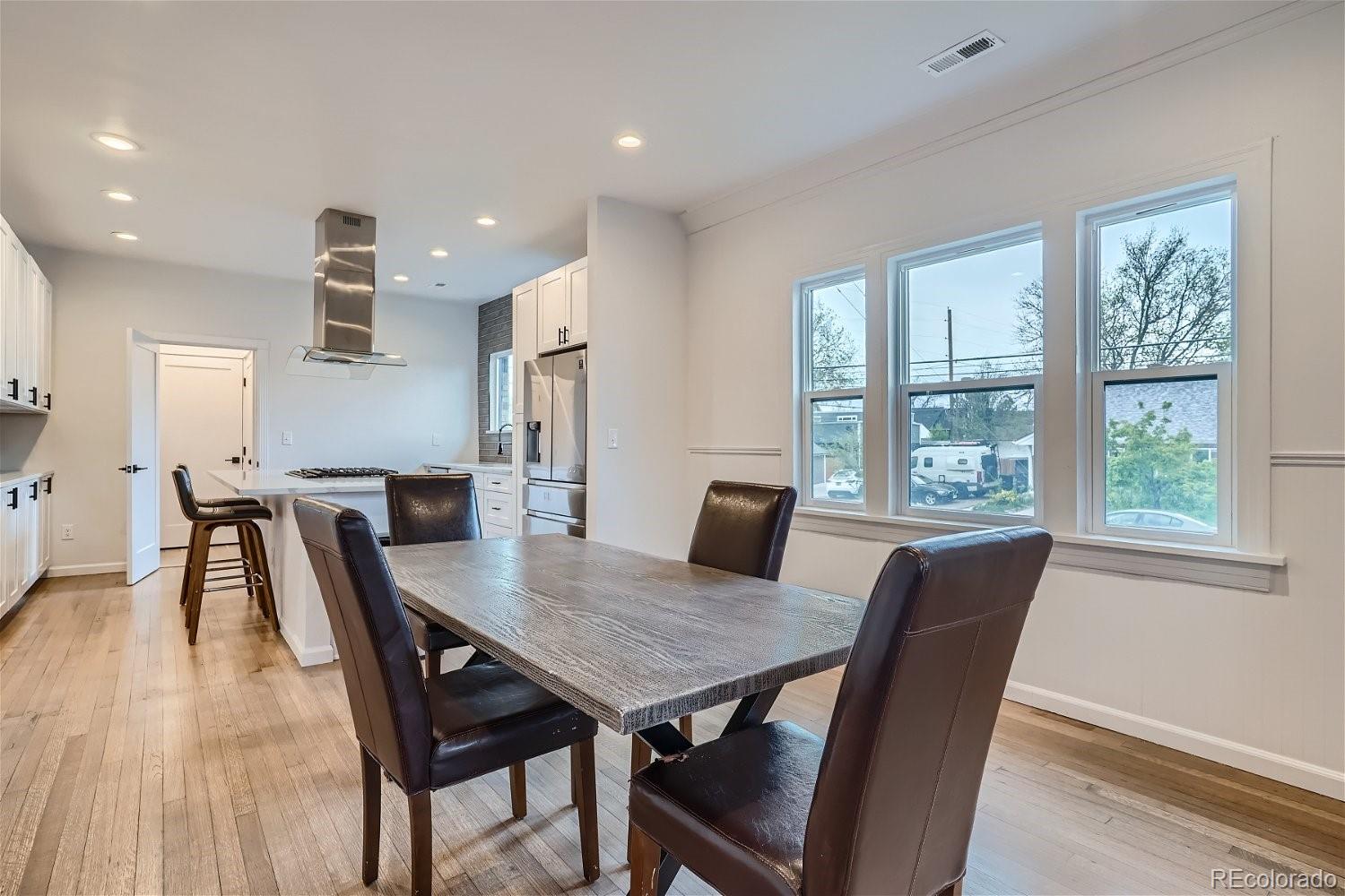 1400 Perry Street Denver, CO 80204 - Photo 8 of 26 a view of a dining room with furniture window and wooden floor