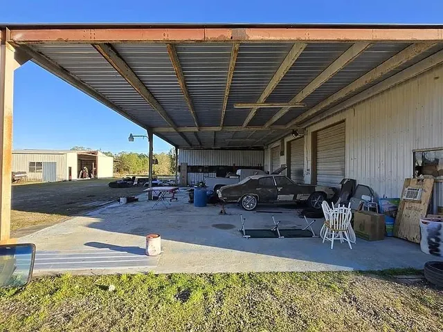 a view of a backyard with table and chairs