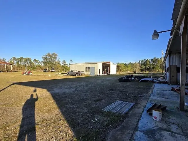 a view of a yard and front view of a house