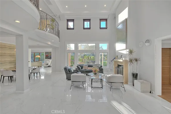 a view of a dining room with furniture and a chandelier