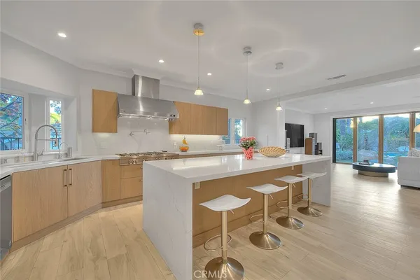 a kitchen with stainless steel appliances kitchen island granite countertop a stove and cabinets