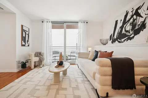 a living room with furniture a window and a table