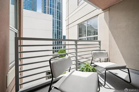 a balcony with table and chairs