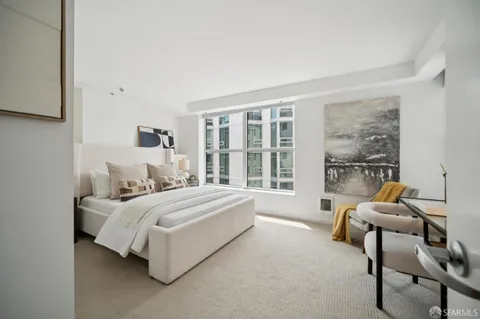 a bed room with a bed and a chair