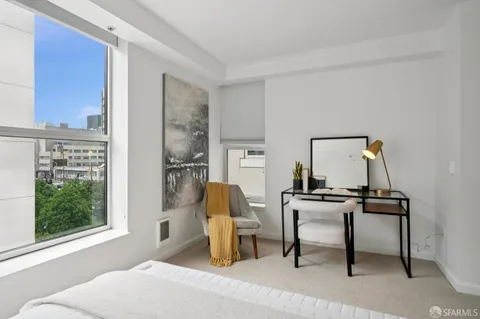 a living room with furniture a window and a fireplace