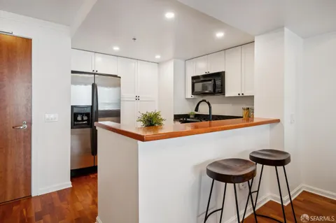 a kitchen with stainless steel appliances a sink and a refrigerator