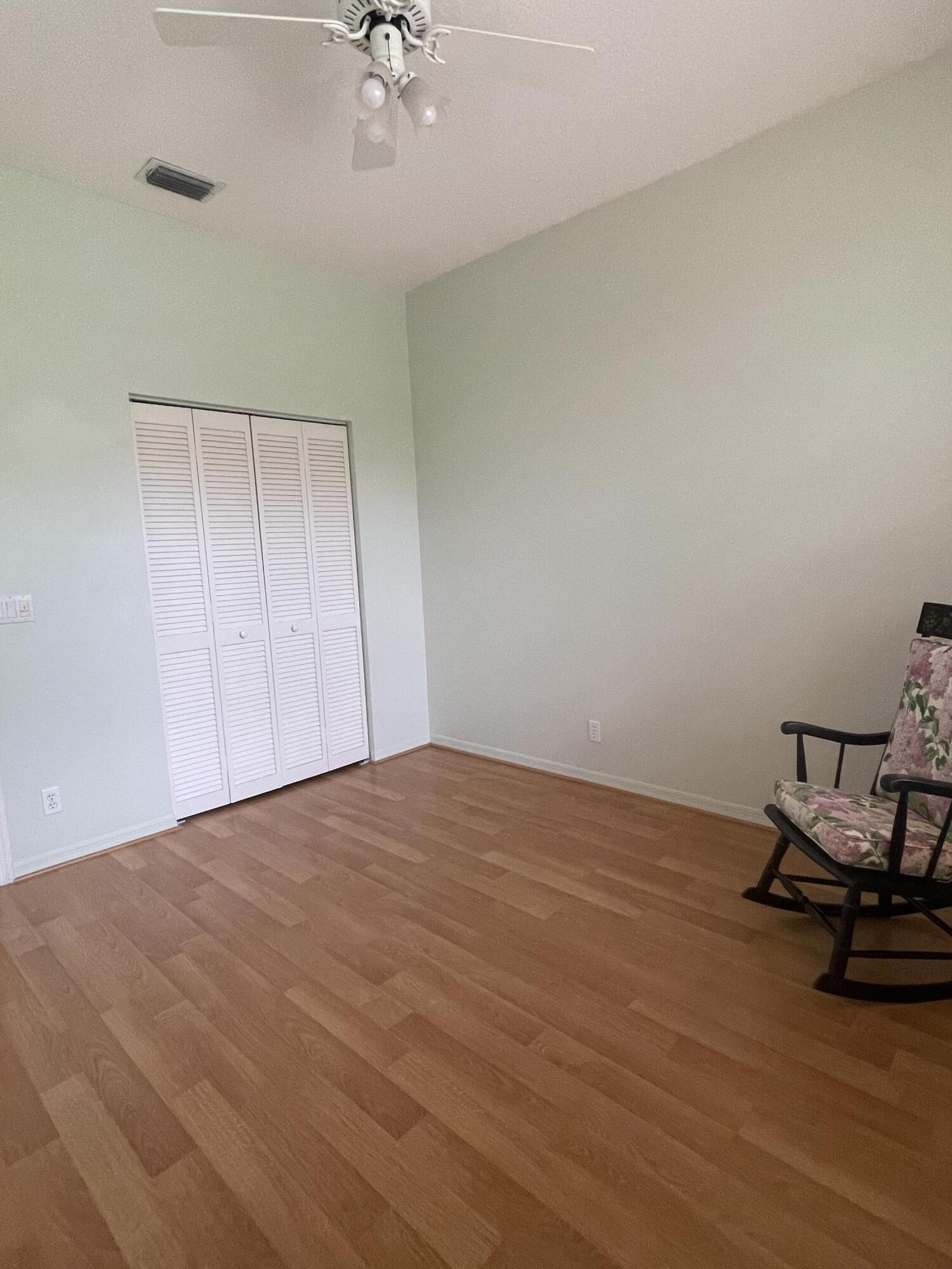22324 Rushmore Place Boca Raton, FL 33428 - Photo 14 of 33 a view of a room with wooden floor and a ceiling fan