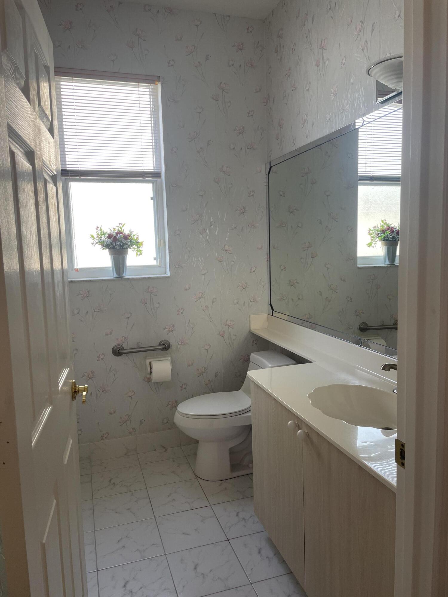 22324 Rushmore Place Boca Raton, FL 33428 - Photo 16 of 33 a bathroom with a sink a toilet and window