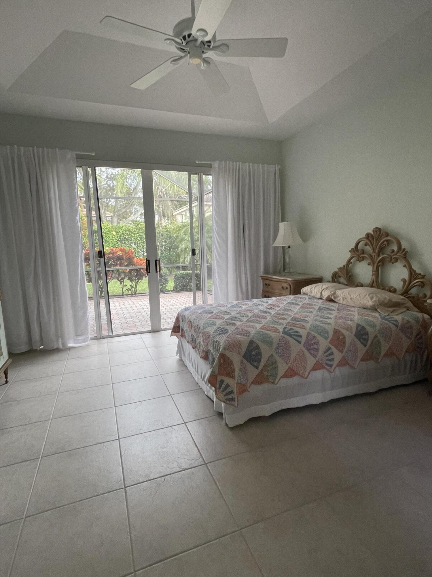 22324 Rushmore Place Boca Raton, FL 33428 - Photo 18 of 33 a bedroom with a bed and a large window