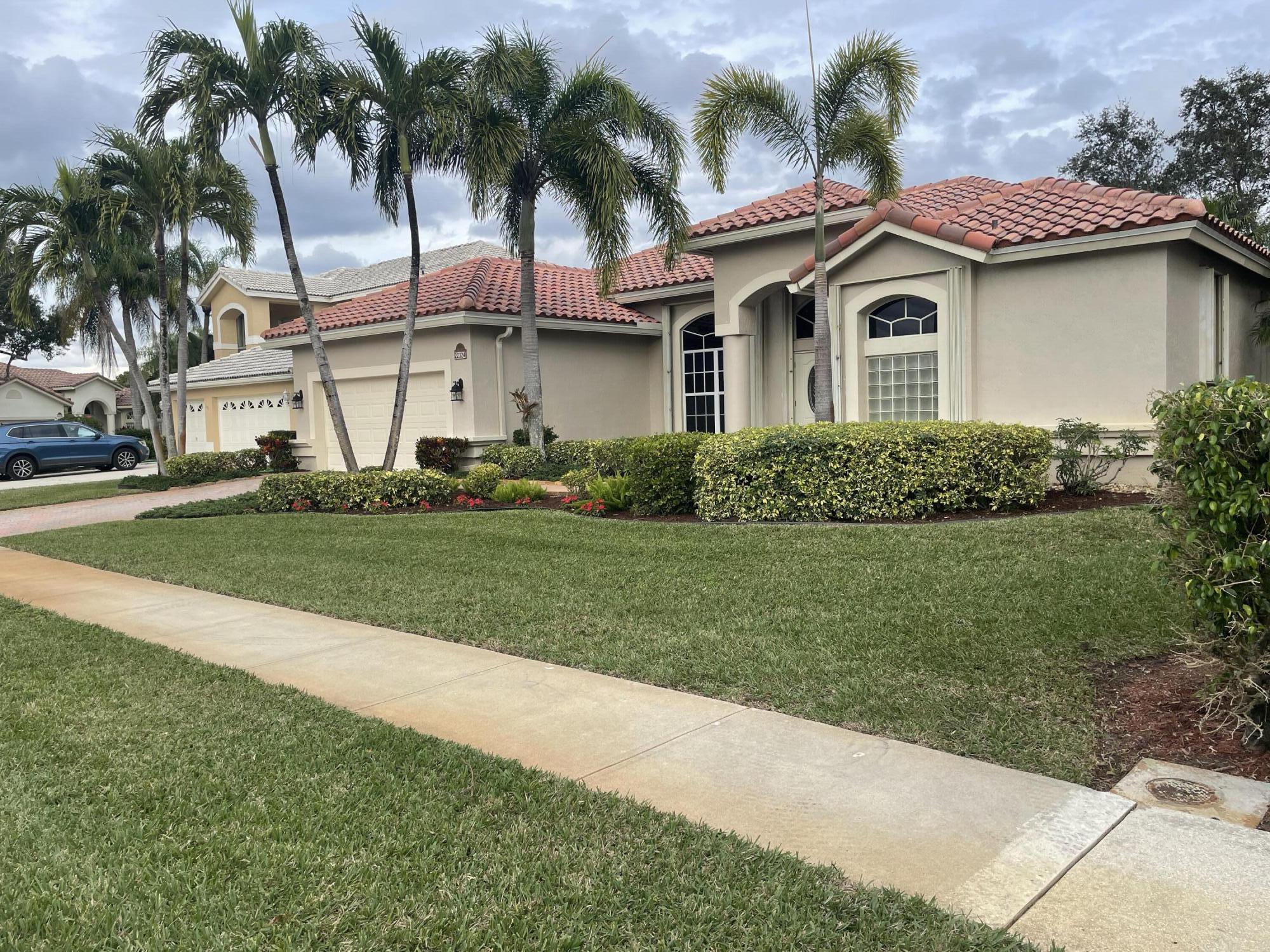 22324 Rushmore Place Boca Raton, FL 33428 - Photo 2 of 33 a yellow and red house with a garden