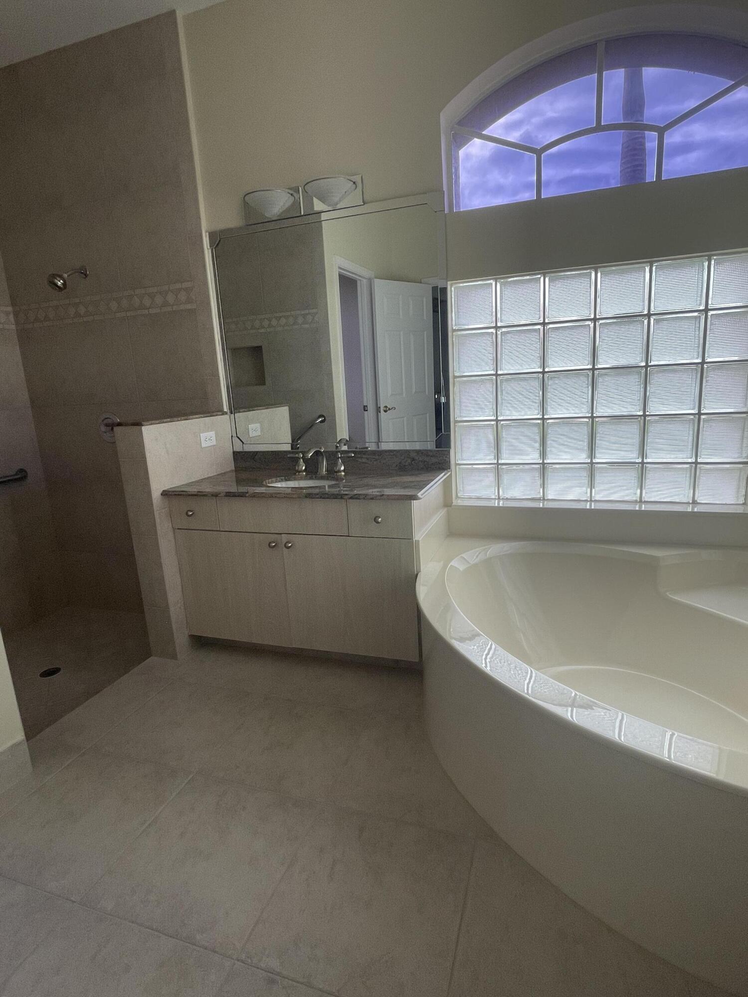 22324 Rushmore Place Boca Raton, FL 33428 - Photo 21 of 33 a bathroom with a bathtub and shower