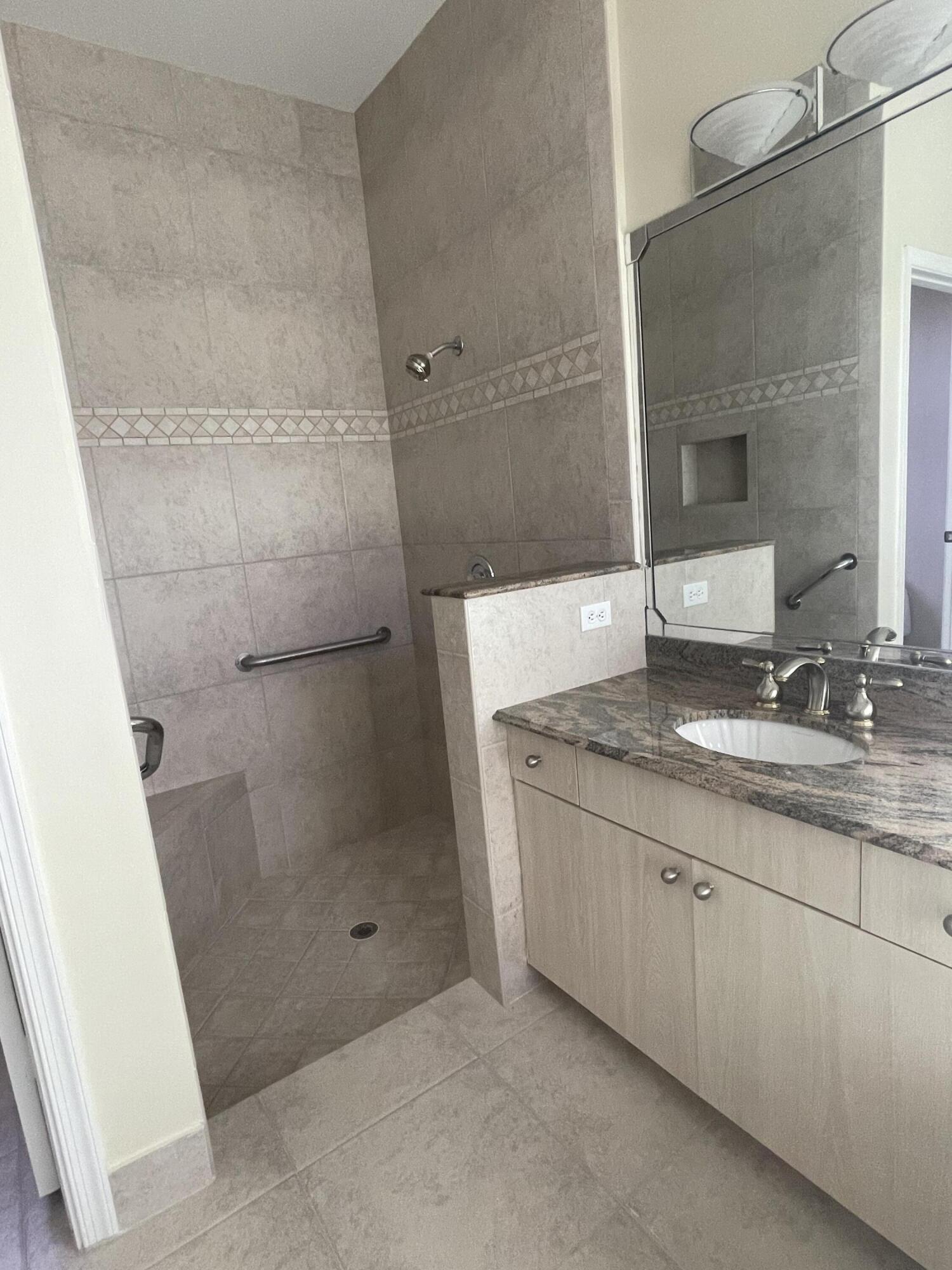 22324 Rushmore Place Boca Raton, FL 33428 - Photo 25 of 33 a bathroom with a granite countertop sink a mirror and shower