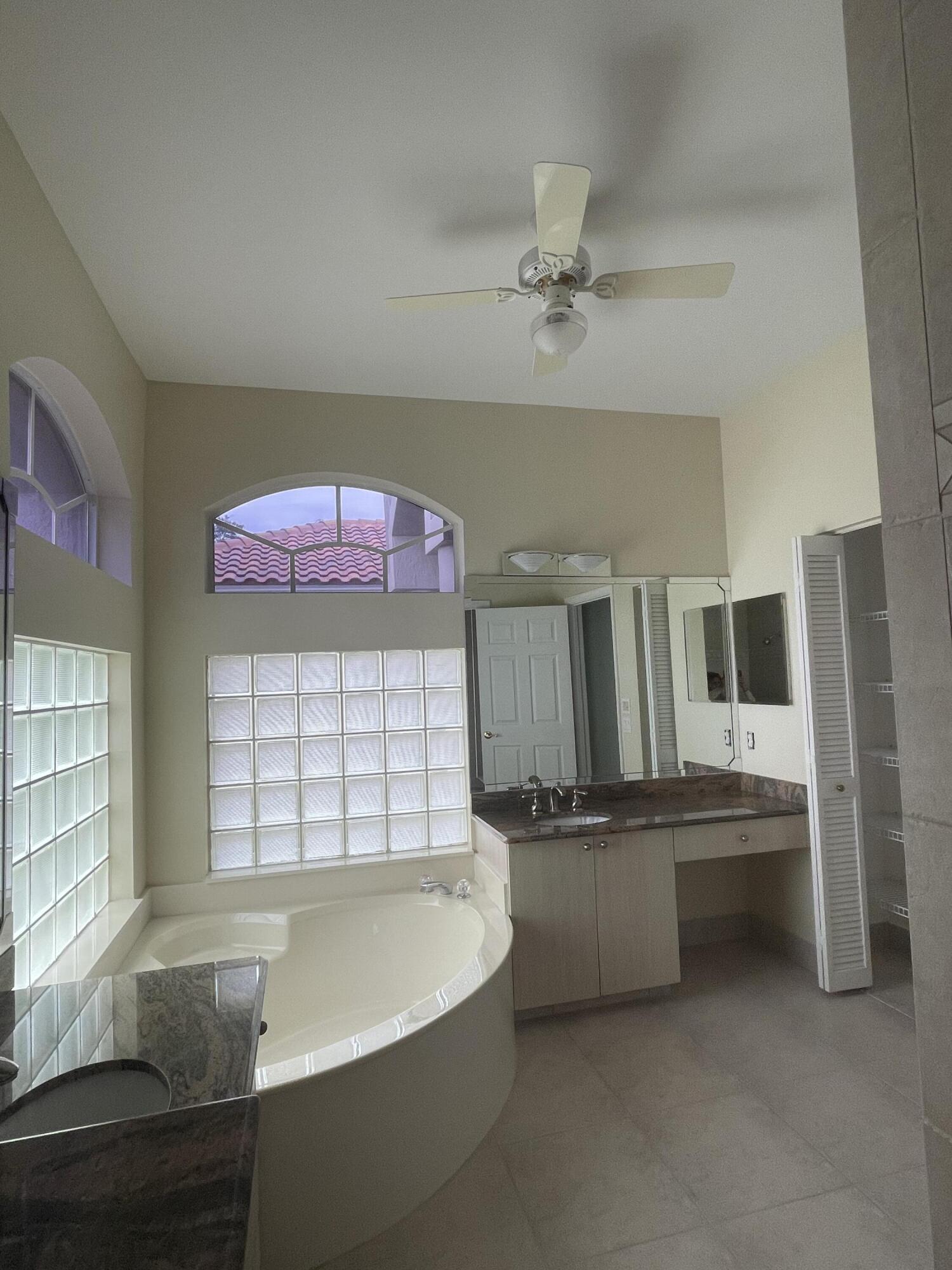 22324 Rushmore Place Boca Raton, FL 33428 - Photo 27 of 33 a kitchen with a sink cabinets and window