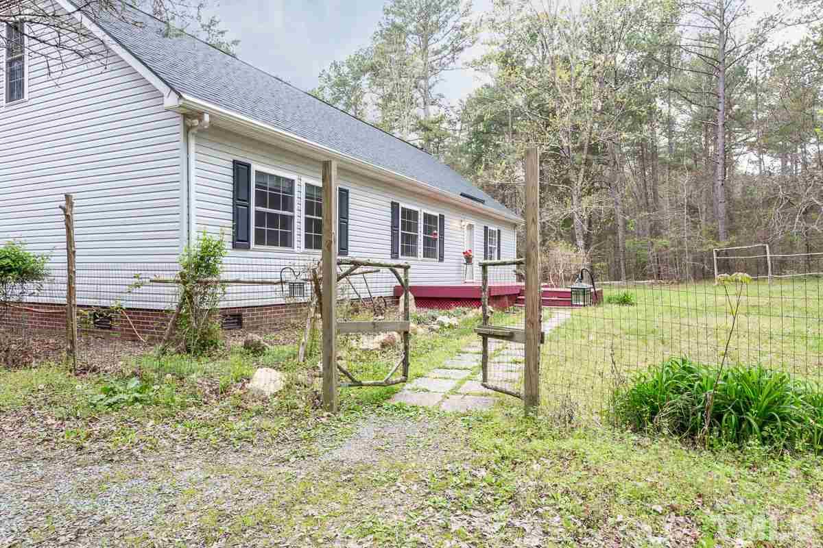 3882 Millard Whitley Road Chapel Hill, NC 27516 - Photo 2 of 20 a view of a house with backyard and sitting area