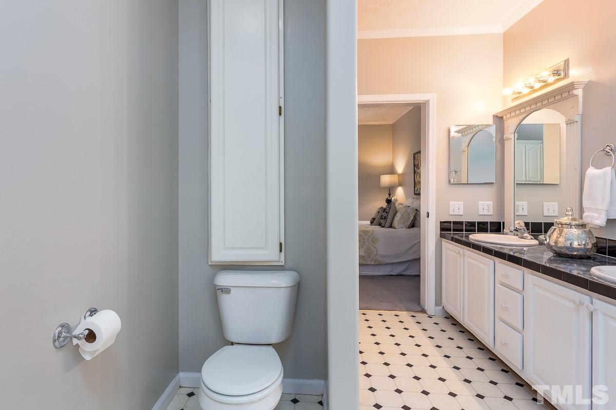 3882 Millard Whitley Road Chapel Hill, NC 27516 - Photo 13 of 20 a bathroom with a toilet a sink and a mirror