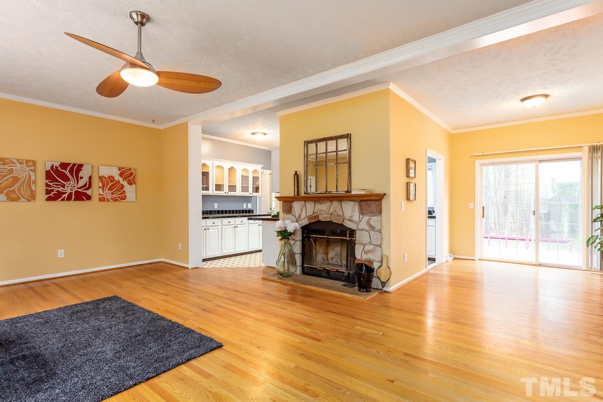 3882 Millard Whitley Road Chapel Hill, NC 27516 - Photo 4 of 20 a view of a livingroom with a fireplace and chandelier