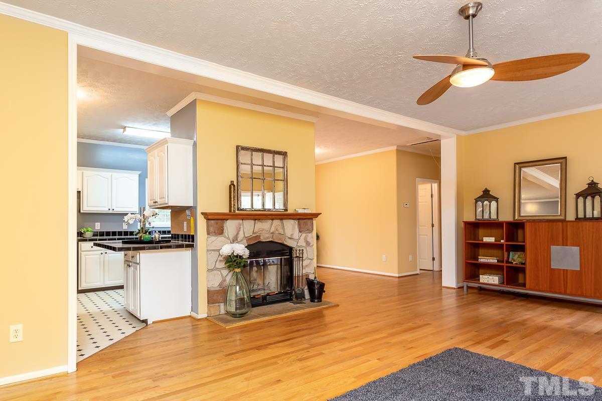 3882 Millard Whitley Road Chapel Hill, NC 27516 - Photo 5 of 20 a view of a kitchen with a stove cabinets and wooden floor