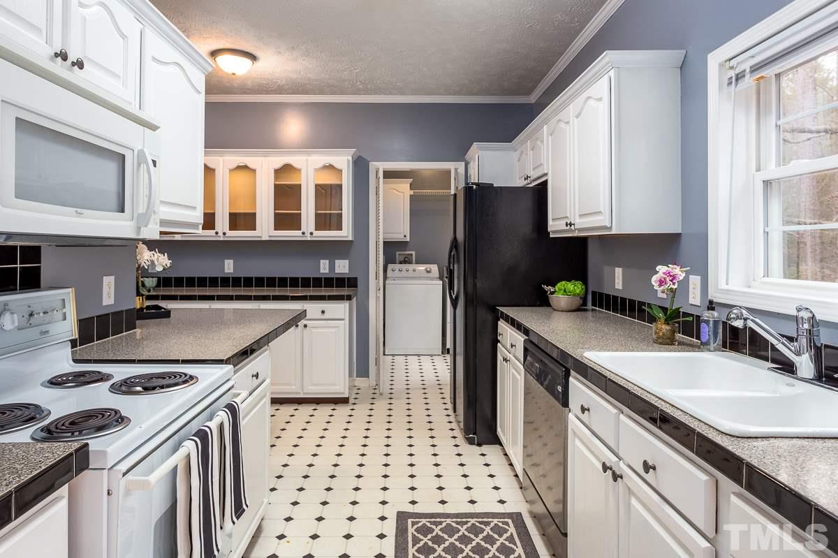 3882 Millard Whitley Road Chapel Hill, NC 27516 - Photo 8 of 20 a kitchen with a sink stove and refrigerator
